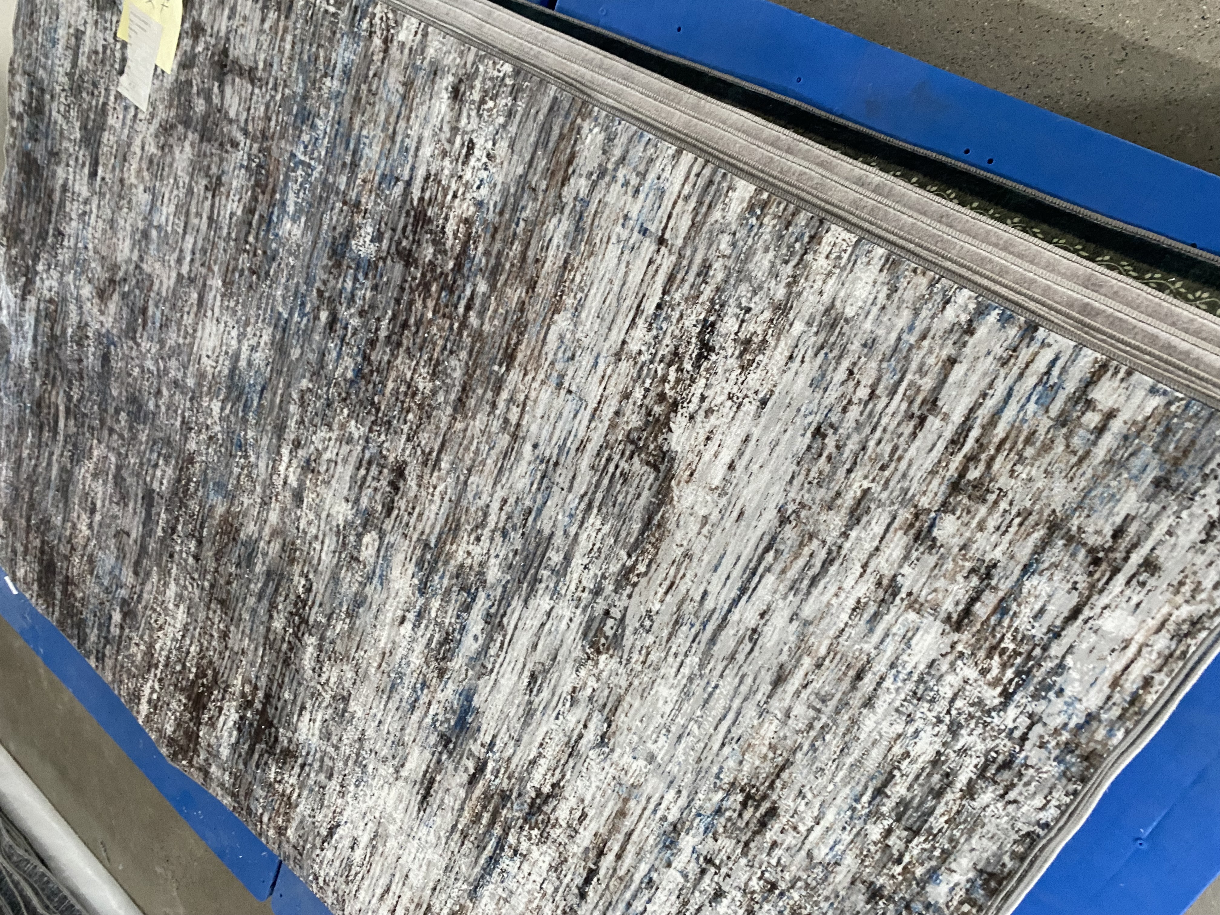 Gray faux-sisal washable rug sample in factory