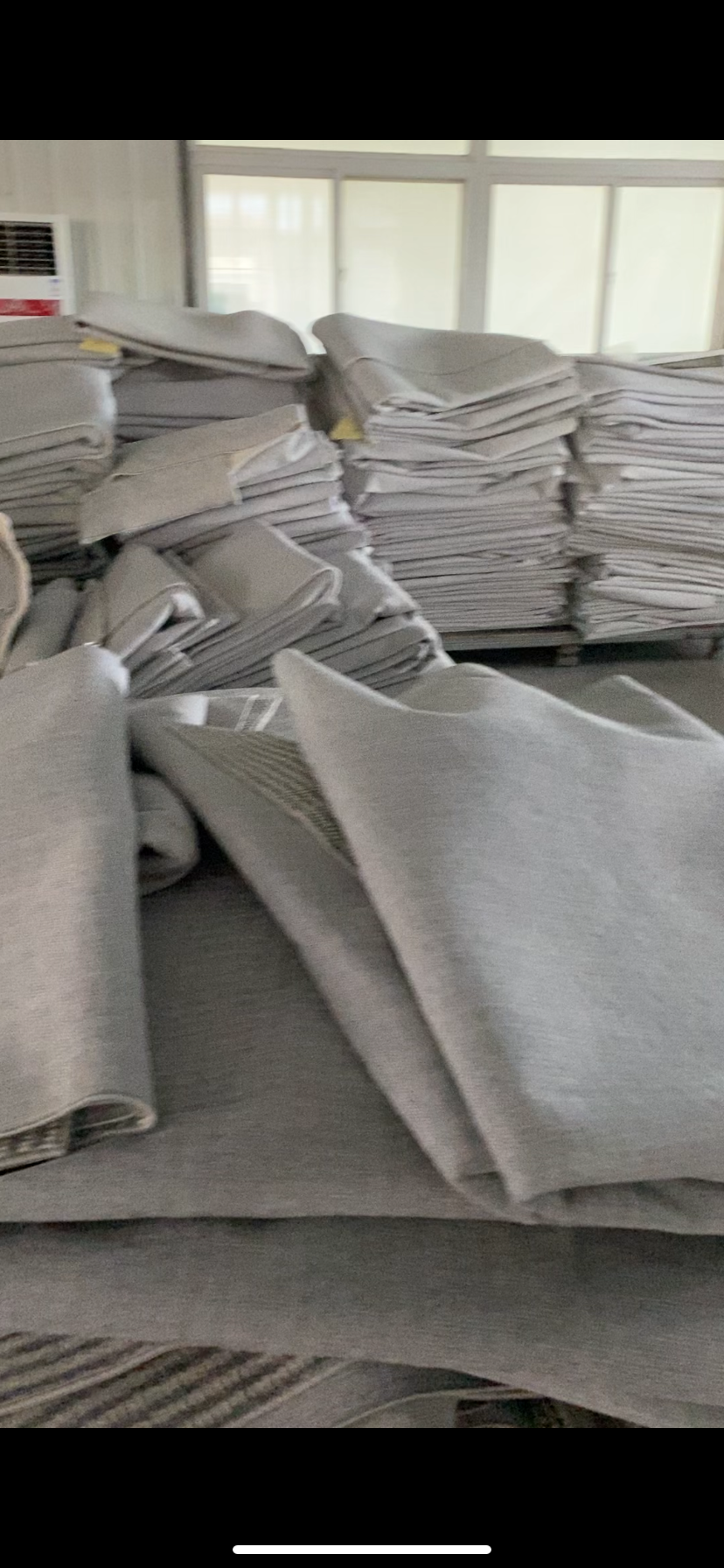 Project carpet gray rug stacks in factory