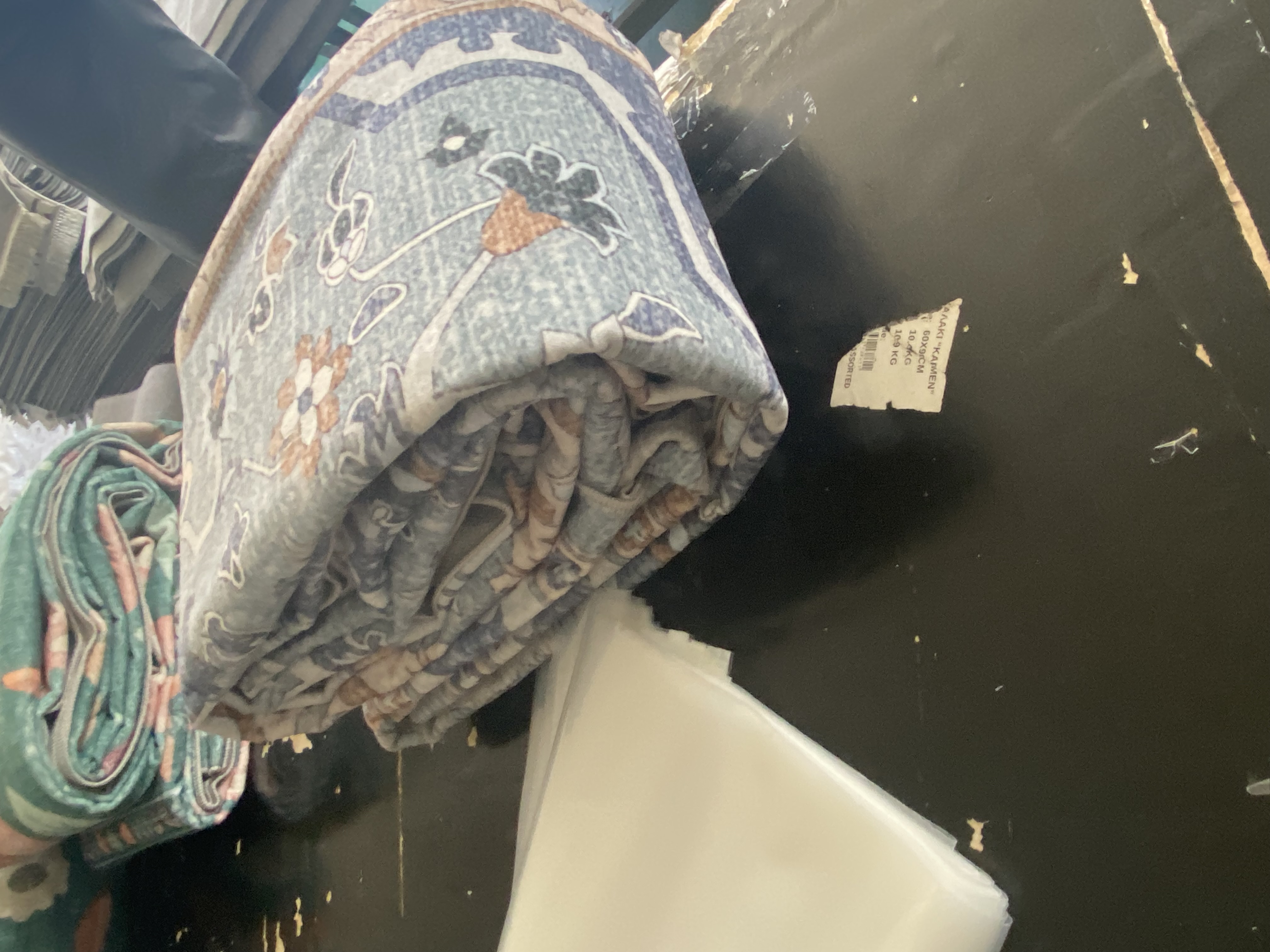 Folded washable area rug sample in factory