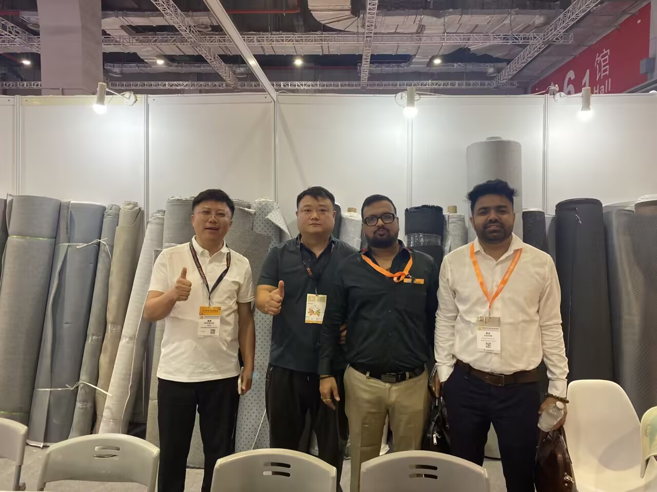 International trade show booth with overseas buyers and rug samples